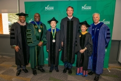 Rector Horace Blackman, President Gregory Washington, previous Mason Medal recipient Kimmy Duong, Commencement speaker and Governor Glenn Youngkin and Provost Mark Ginsberg stand with 2023 Mason Medal recipient Kimmy Duong during the VIP reception before the 2023 Spring Commencement ceremony. Photo by Max Taylor/George Mason University