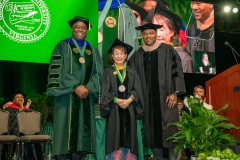 Rector Horace Blackman presents the Mason Medal to Kimmy Duong during the 2023 Spring Commencement at EagleBank Arena. Photo by Max Taylor/George Mason
